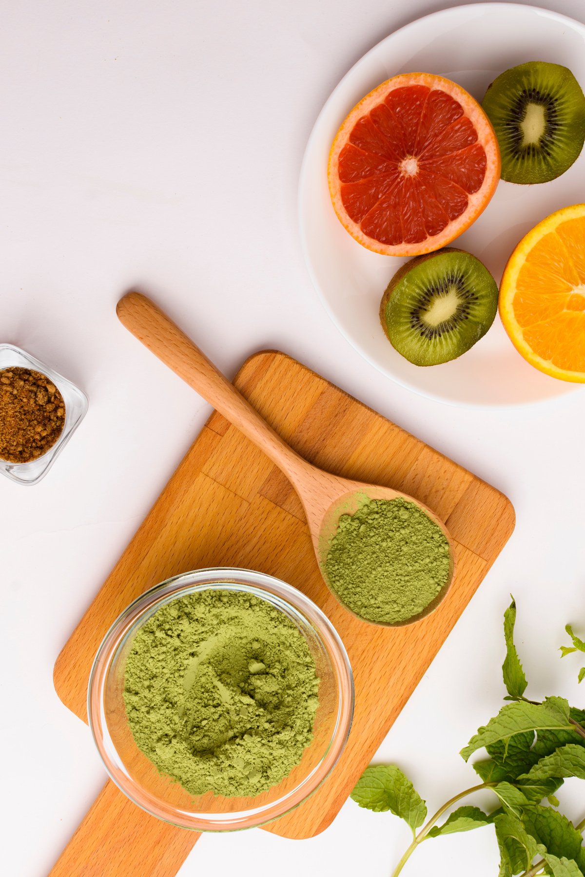 Top View of Bowl of Powder with Greens and Fruits